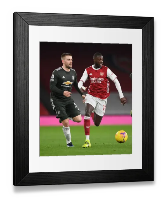 Framed Print : Pepe vs Shaw: Empty Emirates Showdown - Arsenal vs Manchester United in the Premier League Amidst Coronavirus Restrictions (2020-21)