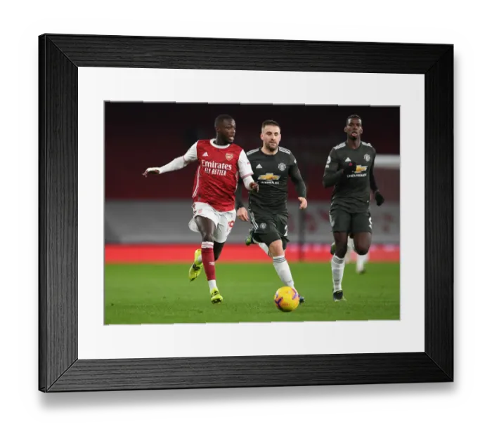 Framed Print : Arsenal vs Manchester United: Pepe vs Shaw in Empty Emirates Stadium (Premier League 2020-21)