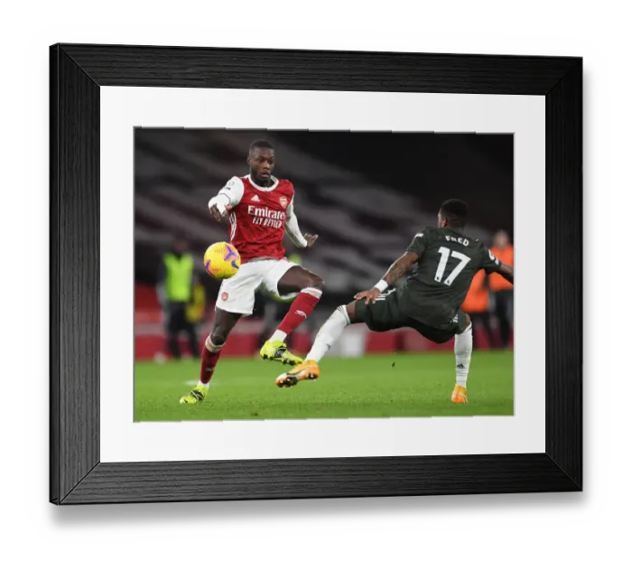 Framed Print : Arsenal vs Manchester United: Pepe Tackles Pressure Amid Empty Emirates Stadium (Premier League 2020-21) Framed Print : Arsenal vs Manchester United: Pepe Tackles Pressure Amid Empty Emirates Stadium (Premier League 2020-21)