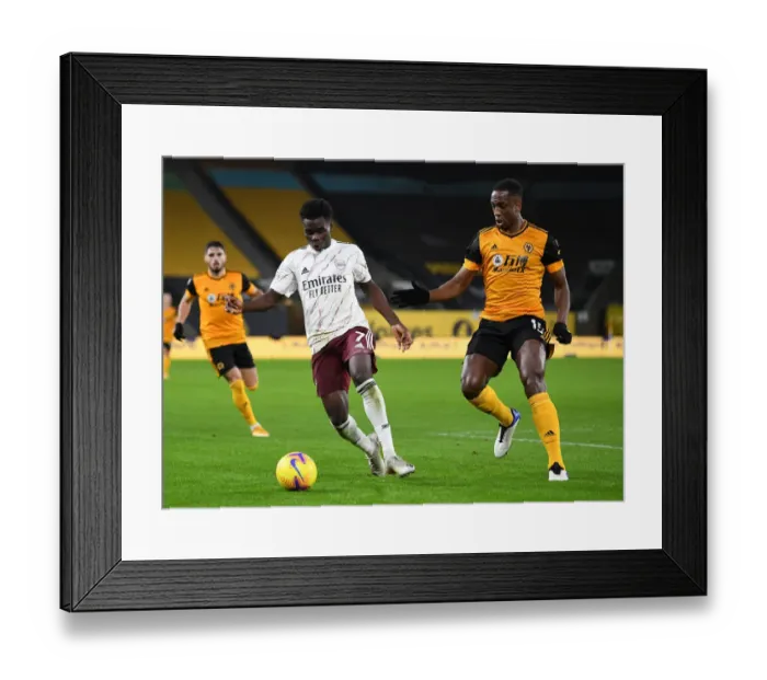 Framed Print : Boly Holds Off Saka: Intense Battle at Molineux in Arsenal's Premier League Clash with Wolverhampton Wanderers