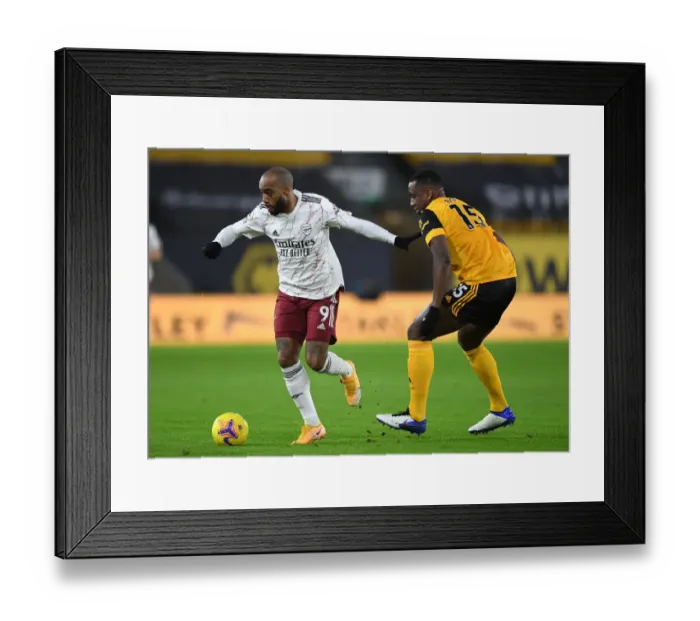 Framed Print : Lacazette vs. Boly: A Premier League Battle at Molineux