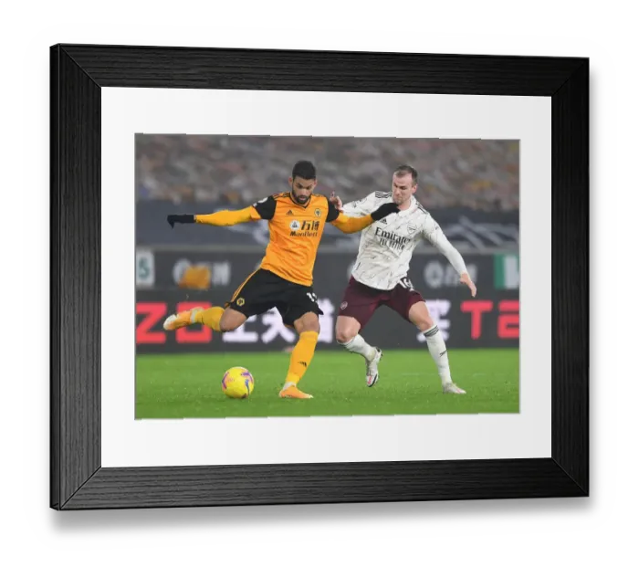 Framed Print : Arsenal's Rob Holding Closes In on Wolverhampton's Willian Jose in Intense Premier League Clash