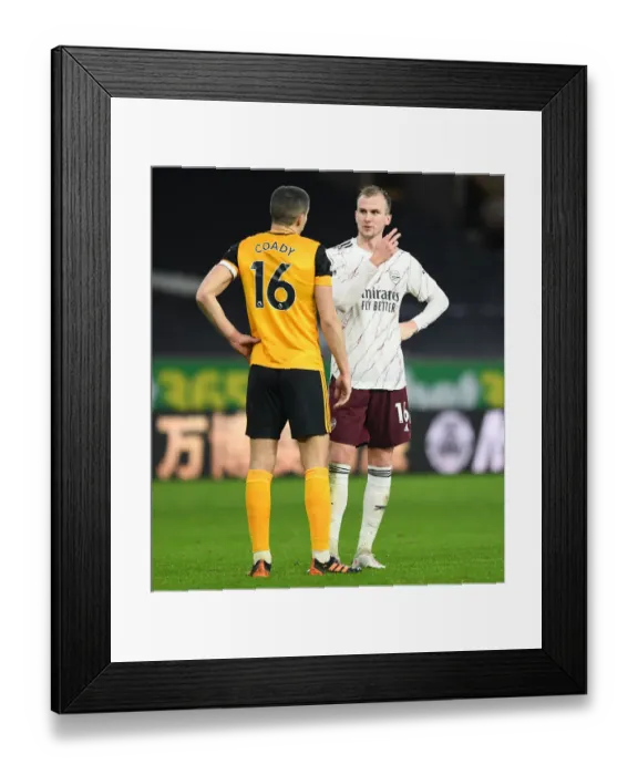 Framed Print : Sportsmanship in Rivalry: Holding and Coady's Heartfelt Moment after Wolverhampton vs Arsenal