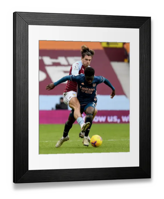 Framed Print : Saka vs Grealish: Intense Battle in Aston Villa vs Arsenal Premier League Clash