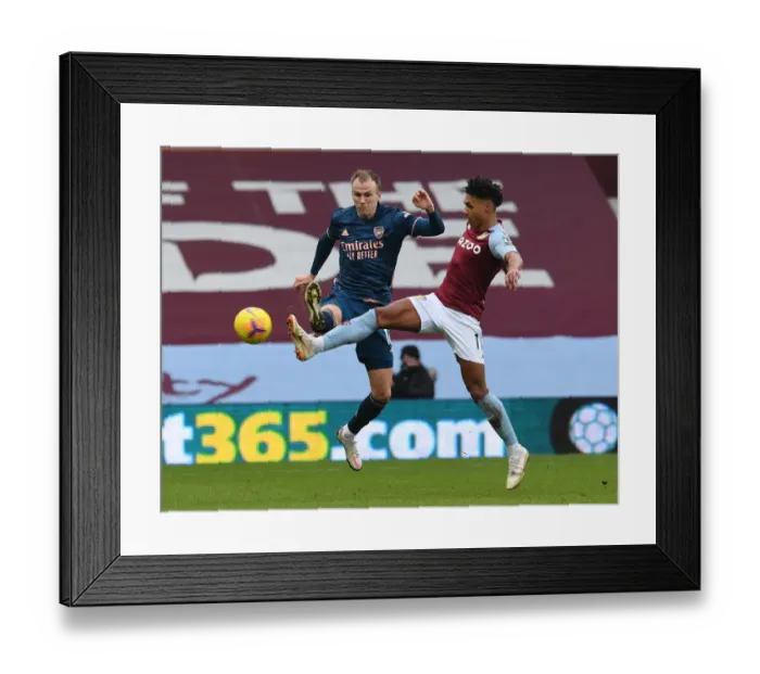 Framed Print : Rising Tensions: Holding vs. Watkins in Aston Villa vs. Arsenal Premier League Clash