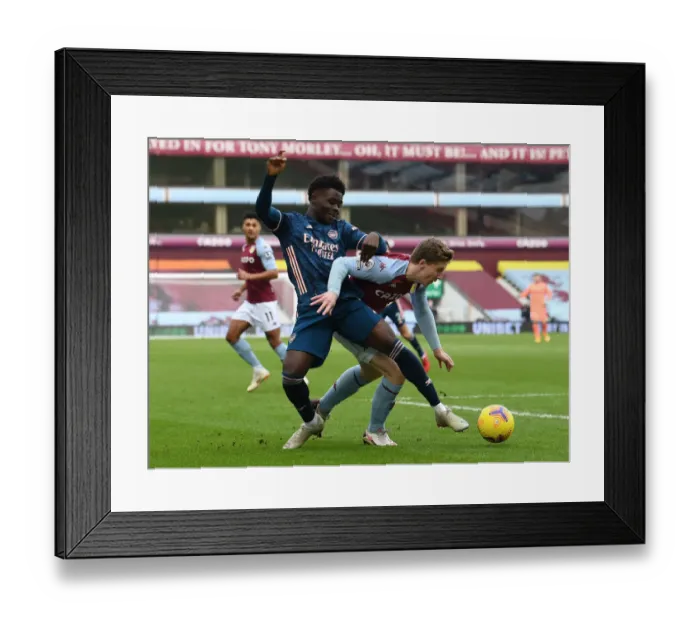 Framed Print : Aston Villa vs Arsenal: Bukayo Saka Faces Off Against Matt Targett