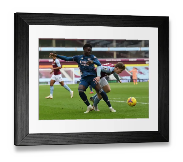 Framed Print : Bukayo Saka vs Matt Targett: Intense Battle at Villa Park - Aston Villa vs Arsenal, Premier League 2020-21