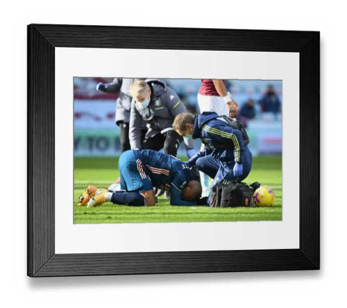 Framed Print : Arsenal's Alex Lacazette Receives Treatment from Physio in Empty Villa Park - Premier League 2020-21