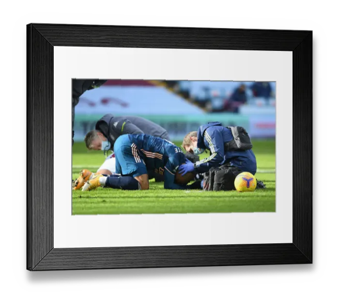 Framed Print : Arsenal's Alex Lacazette Receives Treatment from Physio in Empty Villa Park - Premier League 2021