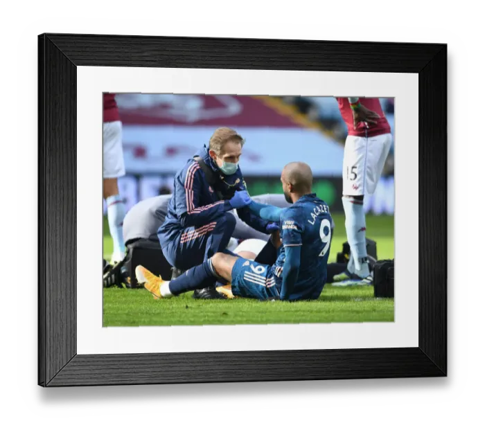 Framed Print : Arsenal's Alex Lacazette Receives Treatment from Physio during Aston Villa Match (Behind Closed Doors), 2021 Framed Print : Arsenal's Alex Lacazette Receives Treatment from Physio during Aston Villa Match (Behind Closed Doors), 2021
