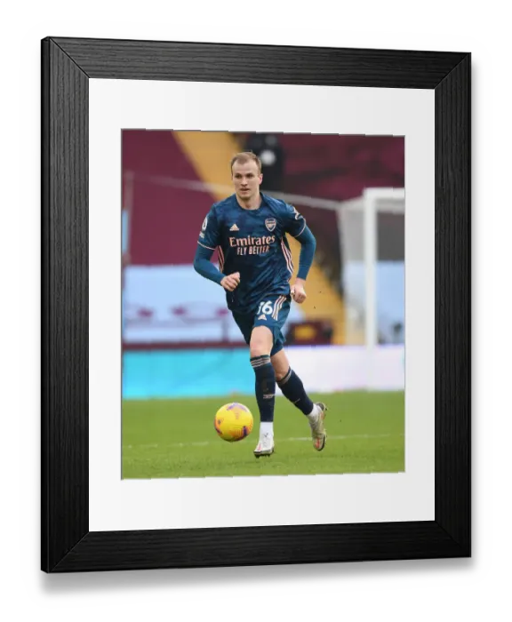 Framed Print : Rob Holding in Action at Empty Villa Park: Arsenal's Premier League Match Amidst COVID-19 Restrictions, February 2021 Framed Print : Rob Holding in Action at Empty Villa Park: Arsenal's Premier League Match Amidst COVID-19 Restrictions, February 2021