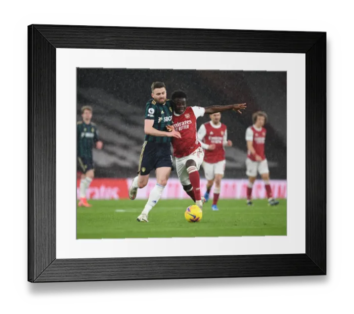 Framed Print : Saka vs. Dallas: Intense Face-Off in Arsenal vs. Leeds United Clash