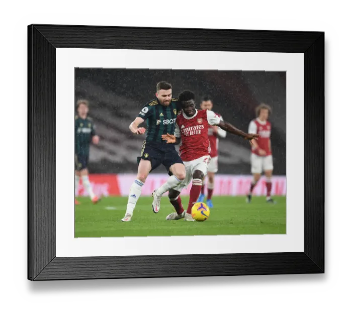 Framed Print : Saka vs Dallas: A Premier League Battle of Young Talents - Arsenal's Rising Star vs Leeds Midfield Mastermind