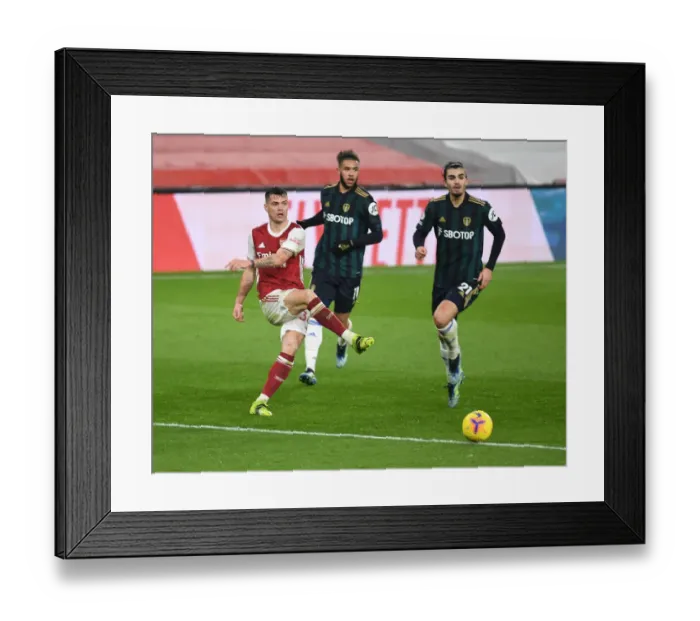 Framed Print : Xhaka vs Struijk: A Hearty Battle in the Arsenal vs Leeds United Clash