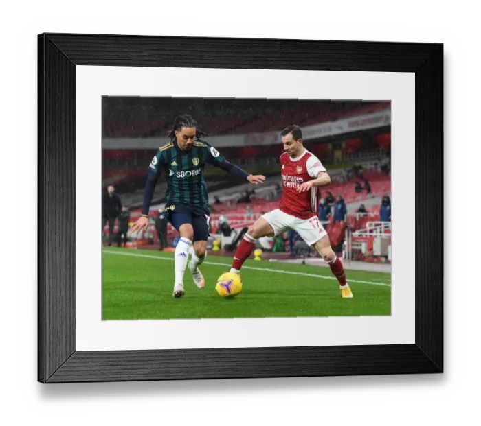 Framed Print : Arsenal vs Leeds United: Cedric Clashes with Helder Costa in Premier League Showdown
