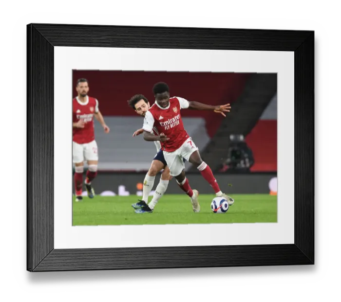 Framed Print : Bukayo Saka Outsmarts Bernardo Silva: A Standout Moment at Empty Emirates Stadium