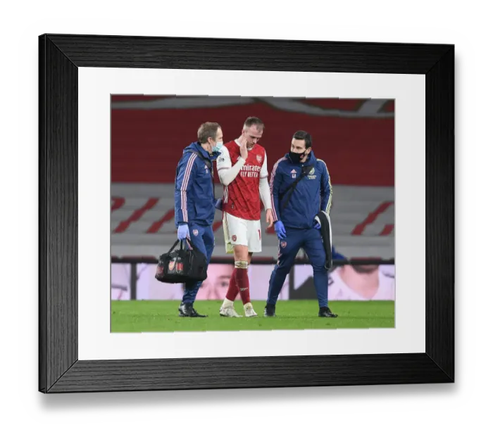 Framed Print : Arsenal v Manchester City: Rob Holding Receives Treatment Amid Strict COVID-19 Protocols