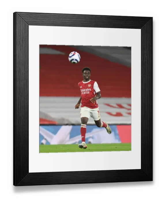 Framed Print : Arsenal's Bukayo Saka Shines in Empty Emirates: Premier League 2020-21 (Arsenal v Manchester City)