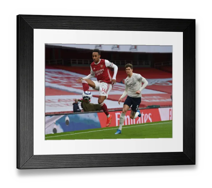 Framed Print : Silent Showdown: Aubameyang vs Stones - Arsenal's Battle Against Manchester City in an Empty Emirates Stadium, Premier League 2020-21