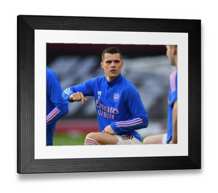 Framed Print : Arsenal v Manchester City: Granit Xhaka Prepares for Premier League Clash Amidst Empty Emirates Stadium (February 2021) Framed Print : Arsenal v Manchester City: Granit Xhaka Prepares for Premier League Clash Amidst Empty Emirates Stadium (February 2021)