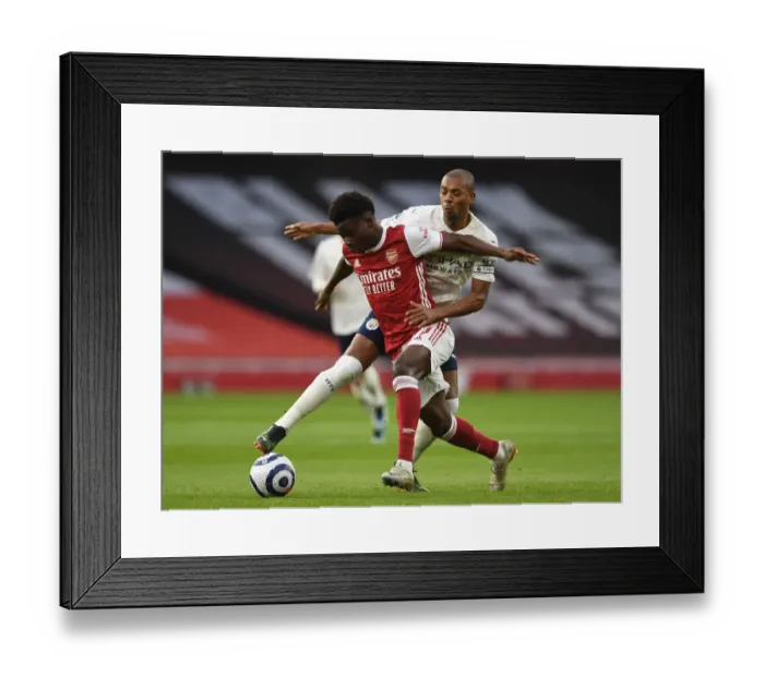 Framed Print : Arsenal vs Manchester City: Bukayo Saka Clashes with Fernandinho in Empty Emirates Stadium