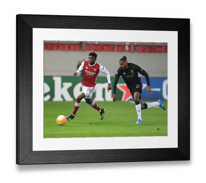 Framed Print : Arsenal's Thomas Partey Clashes with Benfica's Nuno Tavares in Europa League Showdown