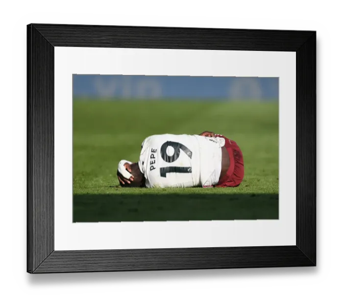 Framed Print : Injured Pepe: Arsenal's Struggle at Leicester Amidst Empty Stands (2020-21)