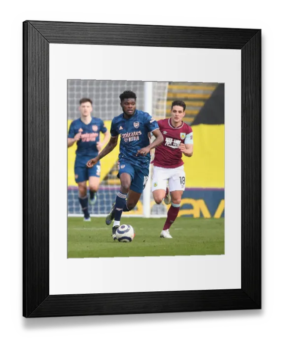 Framed Print : Thomas Partey Breaks Past Burnley's Ashley Westwood in Empty Turf Moor - Arsenal vs Burnley, Premier League 2021 Framed Print : Thomas Partey Breaks Past Burnley's Ashley Westwood in Empty Turf Moor - Arsenal vs Burnley, Premier League 2021