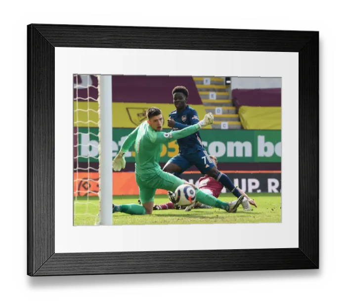 Framed Print : Bukayo Saka Takes a Shot Amidst Burnley's Defense in Empty Turf Moor - Arsenal vs Burnley, Premier League 2020-21 Framed Print : Bukayo Saka Takes a Shot Amidst Burnley's Defense in Empty Turf Moor - Arsenal vs Burnley, Premier League 2020-21
