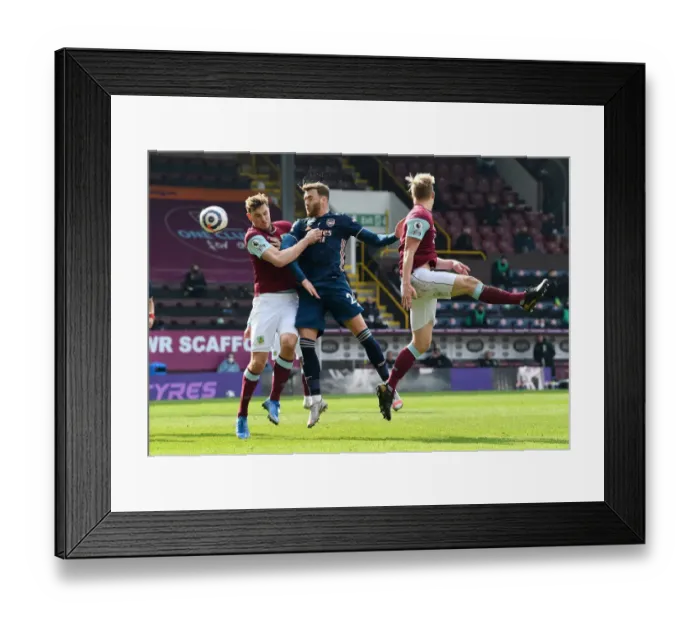 Framed Print : Burnley vs Arsenal: Calum Chambers Faces Off Against Chris Wood Amid Empty Turf Moor Framed Print : Burnley vs Arsenal: Calum Chambers Faces Off Against Chris Wood Amid Empty Turf Moor