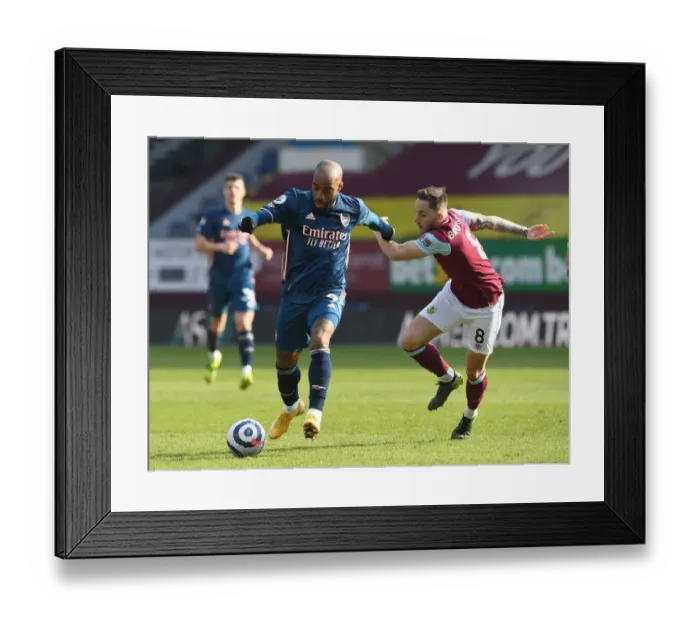 Framed Print : Lacazette vs Brownhill: Empty Turf Moor Clash - Premier League 2020-21: A Battle Between Arsenal's Alexandre Lacazette and Burnley's Josh Brownhill in an Emptied Stadium Framed Print : Lacazette vs Brownhill: Empty Turf Moor Clash - Premier League 2020-21: A Battle Between Arsenal's Alexandre Lacazette and Burnley's Josh Brownhill in an Emptied Stadium