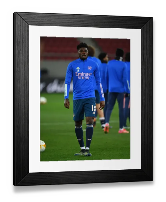 Framed Print : Arsenal's Thomas Partey Prepares for Olympiacos Clash in Empty Europa League Stadium