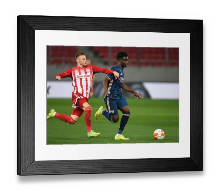 Framed Print : Bukayo Saka vs. Oleg Reabciuk: A Battle in Empty Karaiskakis Stadium - Arsenal's Europa League Clash with Olympiacos