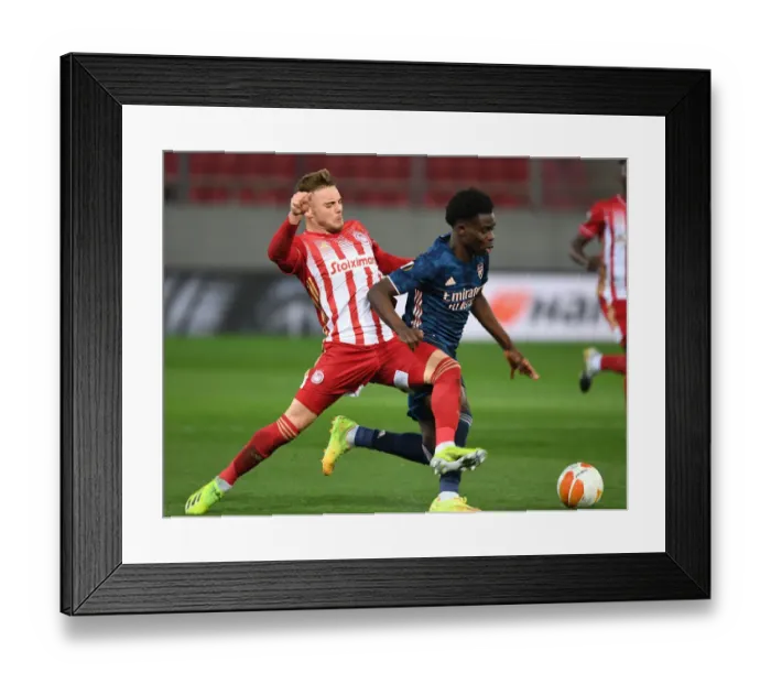 Framed Print : Bukayo Saka vs. Oleg Reabciuk: A Battle in Empty Karaiskakis Stadium - Arsenal's Europa League Clash with Olympiacos Framed Print : Bukayo Saka vs. Oleg Reabciuk: A Battle in Empty Karaiskakis Stadium - Arsenal's Europa League Clash with Olympiacos