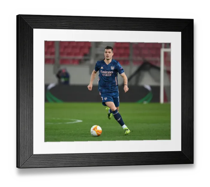 Framed Print : Arsenal's Kieran Tierney in Empty Karaiskakis Stadium: Arsenal vs. Olympiacos in the Europa League Amidst Coronavirus Restrictions