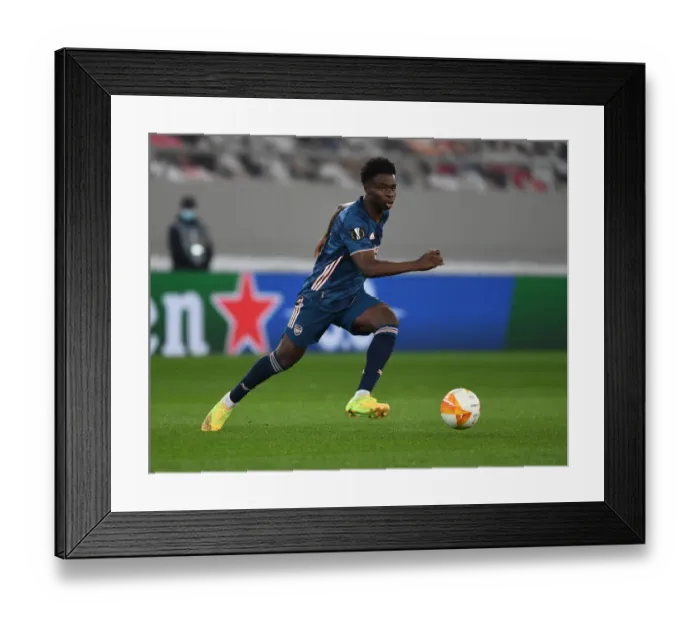Framed Print : Arsenal's Bukayo Saka Shines in Empty Karaiskakis Stadium: Olympiacos vs Arsenal, UEFA Europa League 2021