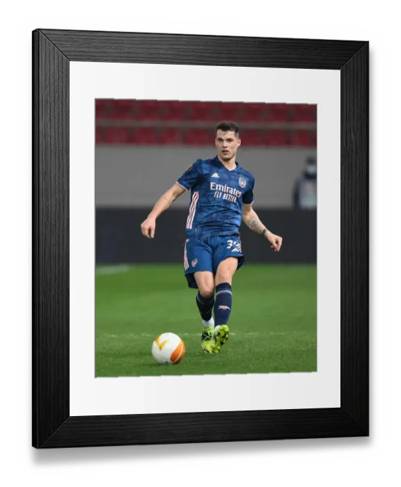 Framed Print : Granit Xhaka in Empty Europa League Action: Olympiacos vs. Arsenal (2020-21)