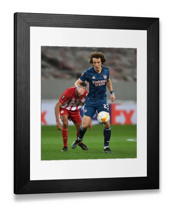 Framed Print : Arsenal's David Luiz Fights On: Empty Europa League Stadium Battle Against Olympiacos Framed Print : Arsenal's David Luiz Fights On: Empty Europa League Stadium Battle Against Olympiacos