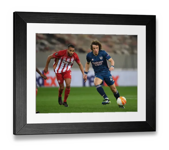 Framed Print : Arsenal's David Luiz Faces Olympiacos in Empty Europa League Stadium