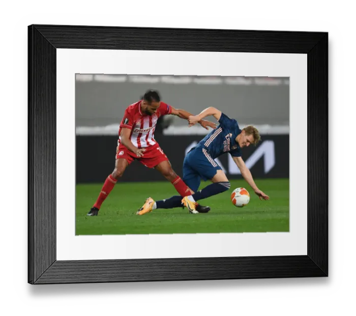 Framed Print : Odegaard vs El Arabi: Clash in Empty Karaiskakis Stadium - Olympiacos vs Arsenal, UEFA Europa League Round of 16