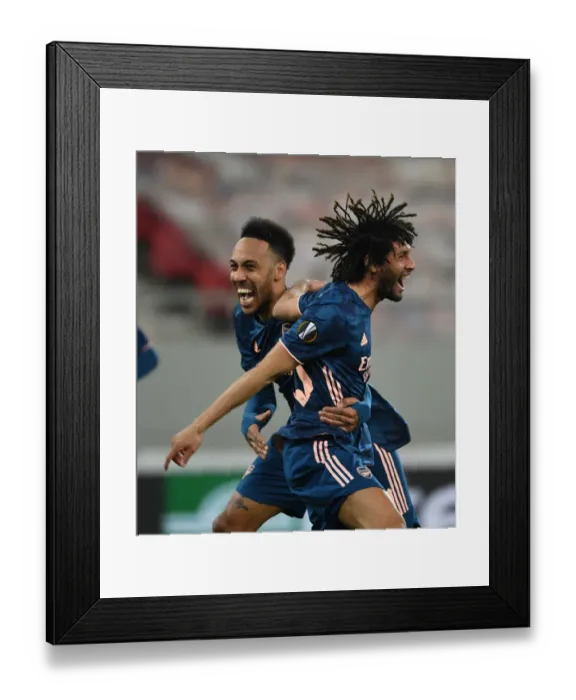 Framed Print : Arsenal's Europa League Victory Amidst Empty Stands: Elneny and Aubameyang Celebrate Goals in Karaiskakis Stadium Framed Print : Arsenal's Europa League Victory Amidst Empty Stands: Elneny and Aubameyang Celebrate Goals in Karaiskakis Stadium