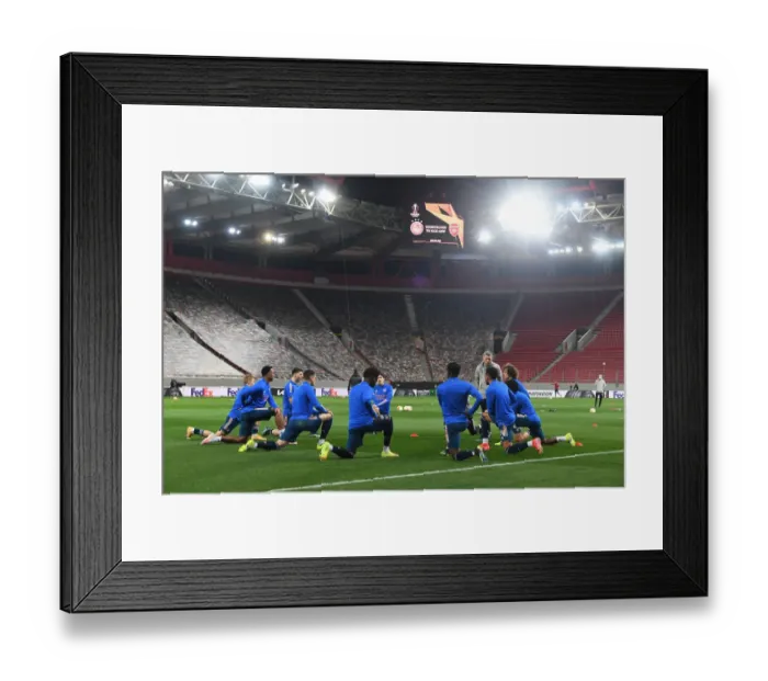 Framed Print : Arsenal's Empty Europa League Clash Against Olympiacos in Piraeus
