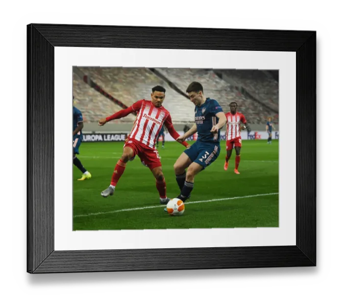 Framed Print : Arsenal's Kieran Tierney Clashes with Olympiacos Kenny Lala in Empty Europa League Stadium