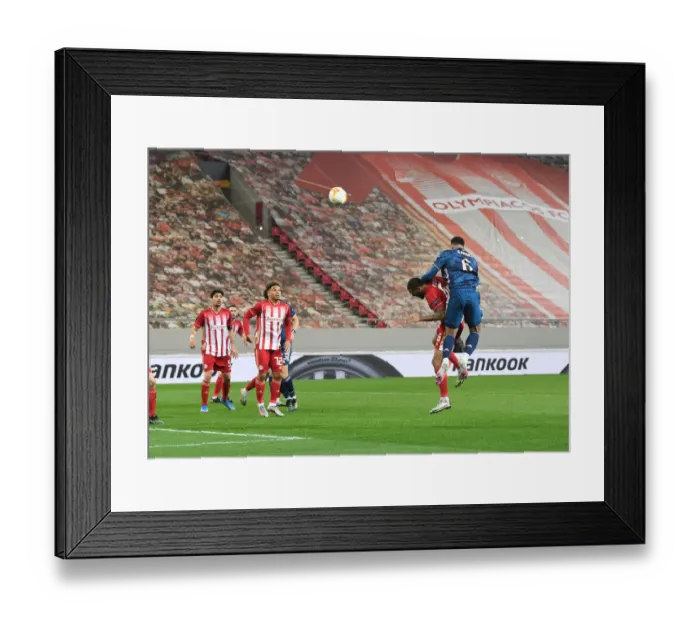 Framed Print : Arsenal Takes 2-0 Lead in Empty Europa League Stadium: Gabriel Scores Against Olympiacos