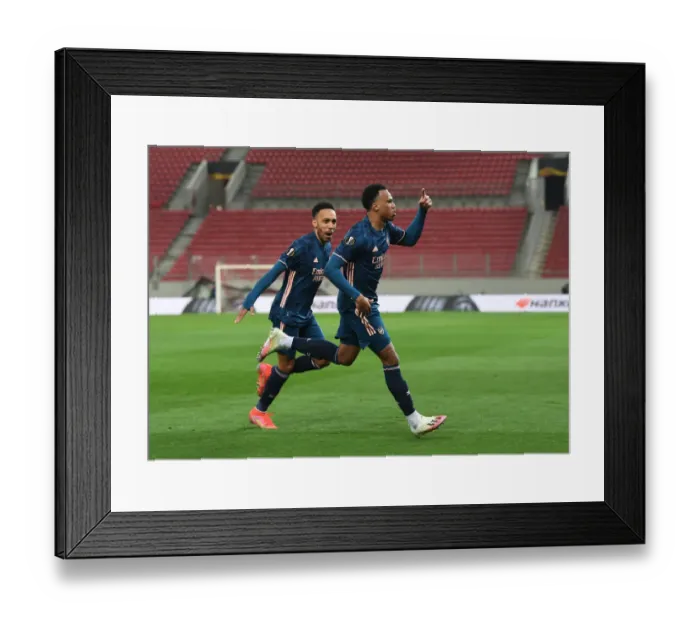 Framed Print : Arsenal's Gabriel and Aubameyang Celebrate Goals in Empty Europa League Match vs. Olympiacos Framed Print : Arsenal's Gabriel and Aubameyang Celebrate Goals in Empty Europa League Match vs. Olympiacos