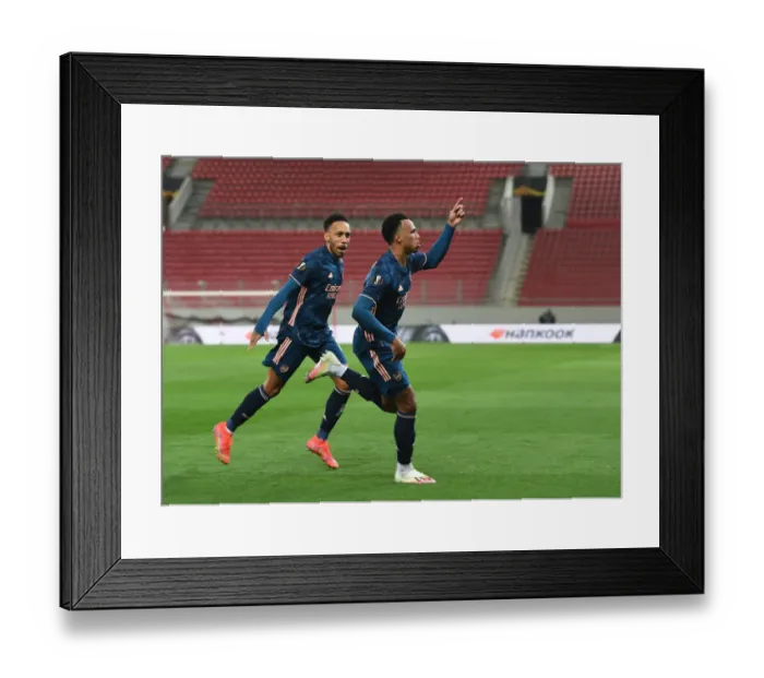 Framed Print : Arsenal's Gabriel and Aubameyang Celebrate Goals in Empty Karaiskakis Stadium during Olympiacos Clash in Europa League Framed Print : Arsenal's Gabriel and Aubameyang Celebrate Goals in Empty Karaiskakis Stadium during Olympiacos Clash in Europa League