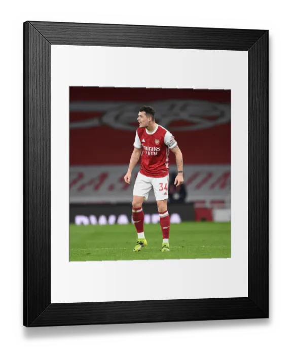 Framed Print : Arsenal's Xhaka Stands Out in Empty Emirates: Arsenal vs. Tottenham (2020-21) Framed Print : Arsenal's Xhaka Stands Out in Empty Emirates: Arsenal vs. Tottenham (2020-21)
