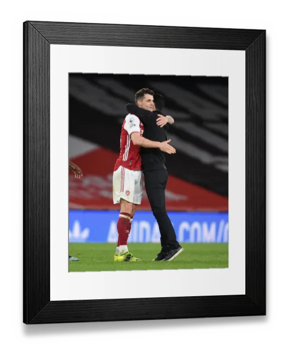 Framed Print : Arsenal's Mikel Arteta Embraces Granit Xhaka Amid Empty Emirates Stadium: Arsenal v Tottenham Hotspur, Premier League 2021 Framed Print : Arsenal's Mikel Arteta Embraces Granit Xhaka Amid Empty Emirates Stadium: Arsenal v Tottenham Hotspur, Premier League 2021