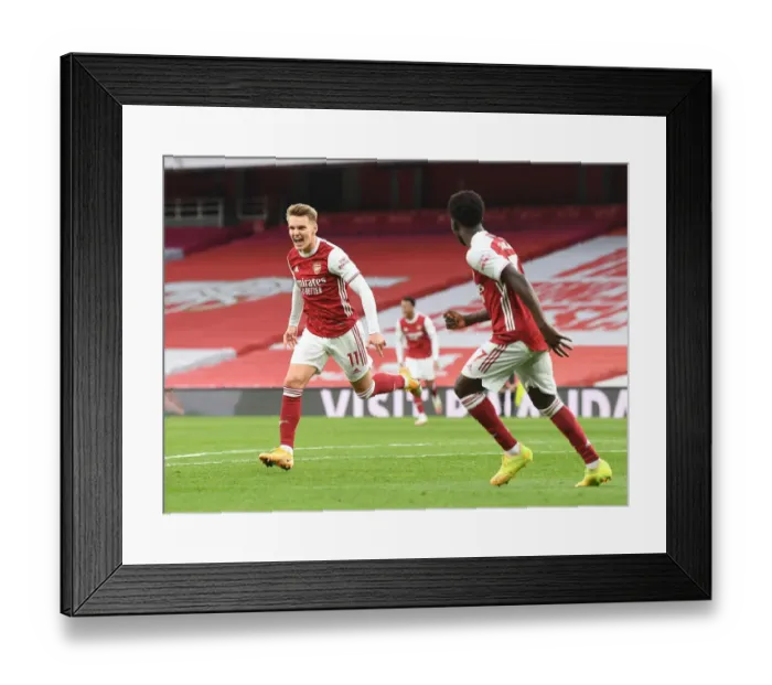 Framed Print : Martin Odegaard Scores Thrilling Winner: Arsenal Edges Past Tottenham in Empty Emirates Stadium