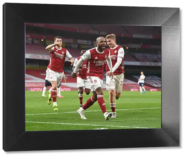 Arsenal's Lacazette, Xhaka, and Smith Rowe Celebrate Goals Against Tottenham in Empty Emirates Stadium
